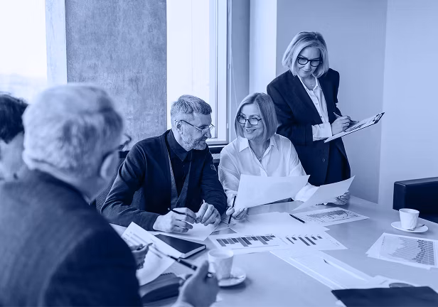 Four people looking at bar charts