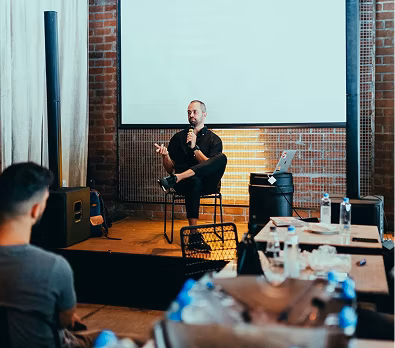 Image of Man talking on a stage